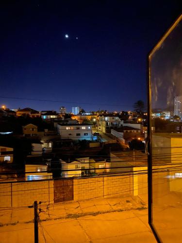 a view of a city at night at CasaOcho in Viña del Mar