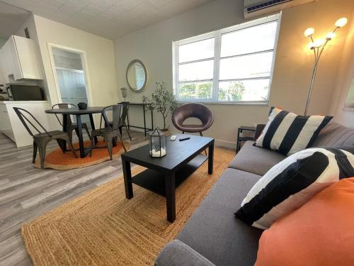 a living room with a couch and a table at Fully equipped Apartments with parking near Cocowalk in Miami