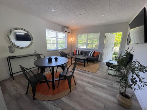 a living room with a table and chairs at Fully equipped Apartments with parking near Cocowalk in Miami
