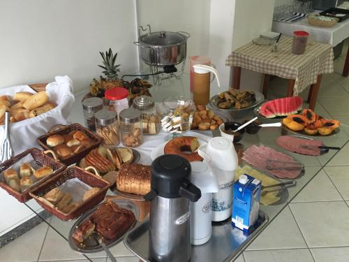 a table with many different types of food on it at Hotel Sol e Mar in Vitória