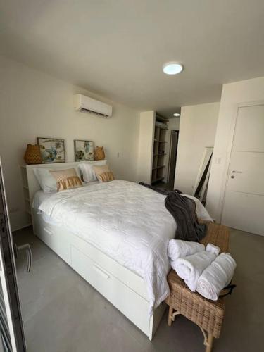 a bedroom with a large bed with towels on a table at Apartment in Playa Nueva Romana in San Pedro de Macorís