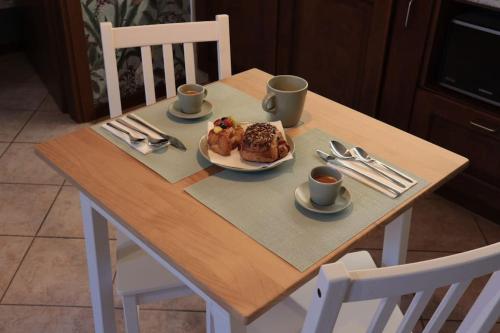 a table with a plate of food and two cups of coffee at La Trinità in Bovo