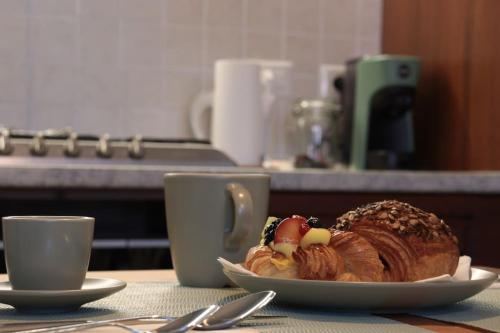 a plate with a croissant on a table with two cups at La Trinità in Bovo