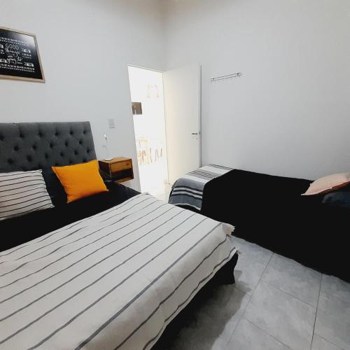 a bedroom with two beds in a room at Aires del sur Patagonia I Departamento N°5 in Río Gallegos