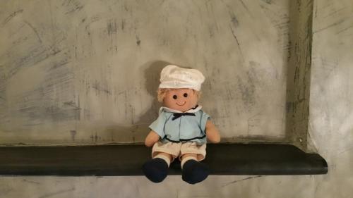 a stuffed teddy bear sitting on a shelf at La Pulce Argentata in Sestri Levante