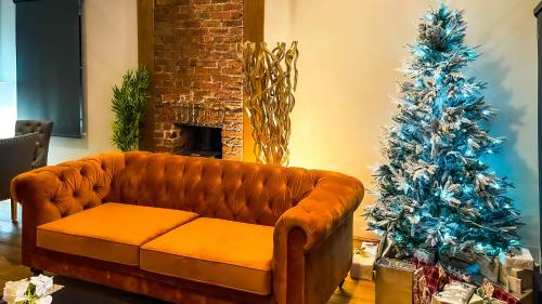 a living room with a couch and a christmas tree at The Coach House - Traveller Award 2026 - A stunning three-storey property nestled in the heart of the lanes complete with secure private parking in Brighton & Hove