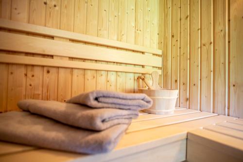 a pile of towels sitting on a table in a sauna at Naturzeithof in Hirschegg