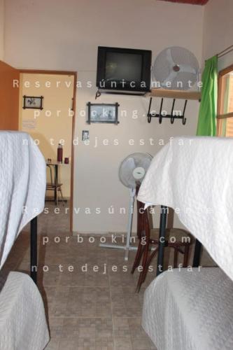 a room with two beds and a projection screen at Alojamientos en Cosquín in Cosquín