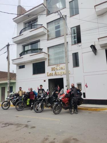 a group of motorcycles parked in front of a building at Hotel los angeles in Huaral