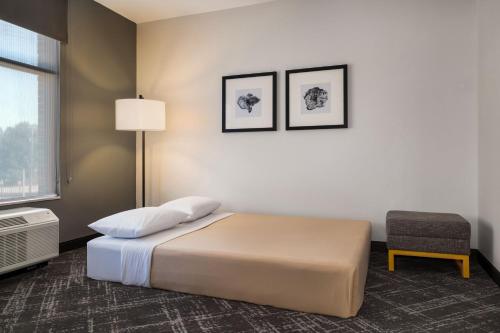 a hotel room with a bed and a chair at TownePlace Suites by Marriott Memphis Germantown in Memphis