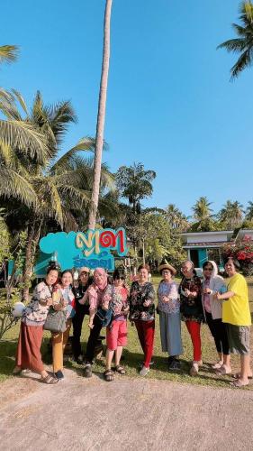 a group of people standing in front of a sign at Yada Resort Koh Yao Noi in Ko Yao Noi