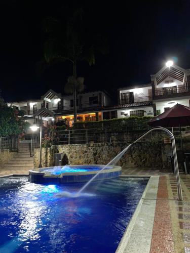 a water fountain in a swimming pool at night at RANCHO SAN LUIS, Páramo in Páramo