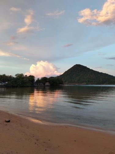 a view of a beach with a mountain in the distance at Bong's Guesthouse M'Pai Bay in Koh Rong Sanloem