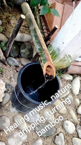 a black bucket of water sitting on the ground at Dreamer Resort in San Vicente