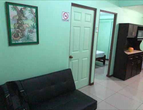 a living room with a couch and a door at Eco Cabinas Familiar in Puntarenas