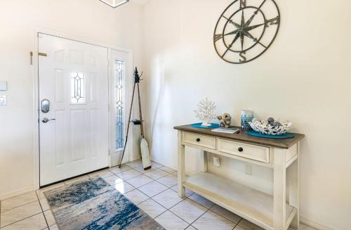 a room with a table and a clock on the wall at Lazy Palm Retreat Heated Pool Jacuzzi Gulf Canal in North Fort Myers