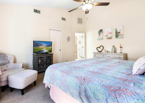 a bedroom with a large bed and a tv at Lazy Palm Retreat Heated Pool Jacuzzi Gulf Canal in North Fort Myers