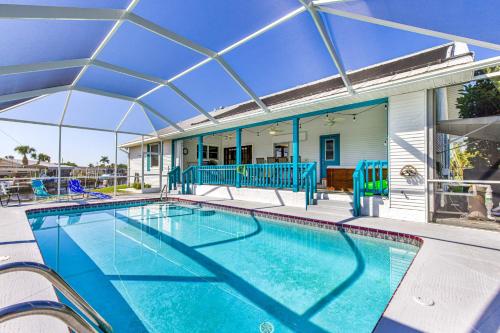 a large swimming pool with a roof over it at Lazy Palm Retreat Heated Pool Jacuzzi Gulf Canal in North Fort Myers