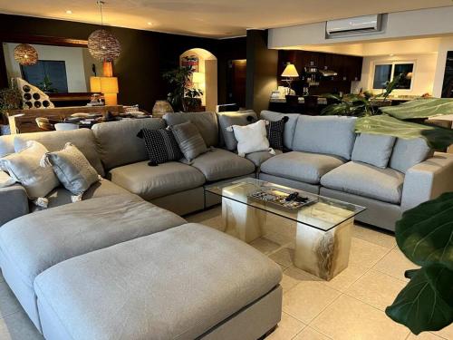 a living room with a couch and a table at BEACH GETAWAY! Luxury Beachfront Condo in Punta de Mita! in Punta Mita