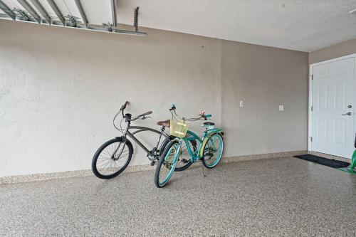 two bikes parked against a wall in a room at Charming Luxury Heated Pool Home in Cape Coral