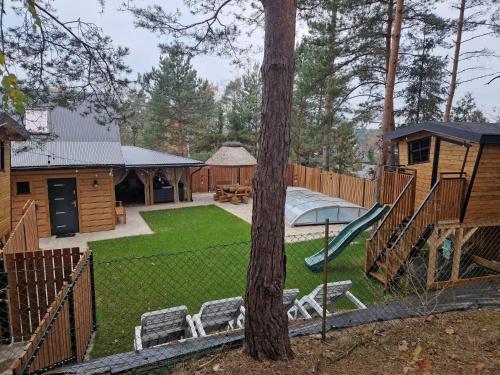 a backyard with a playground and a tree at GÓRALÓWKA - Radawa in Radawa