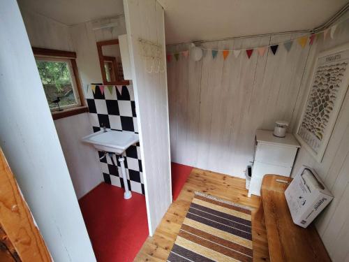 a small room with a checkerboard pattern on the wall at 5 person holiday home in KARLSKOGA in Karlskoga