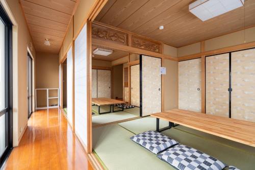 a sauna with benches and tables in a room at Hamanoakariya Kujukuri in Katakai