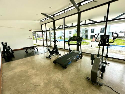 a gym with treadmills and ellipticals in a building at Viva Jaco 9-05 in Jacó
