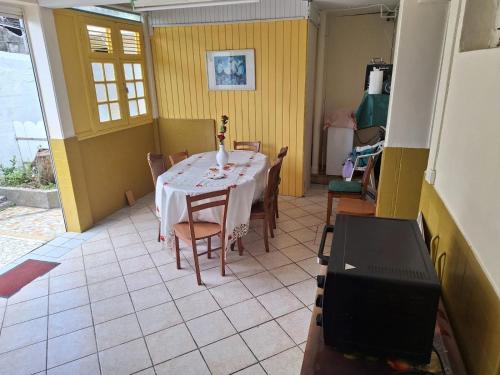 a dining room with a table and chairs at Le Rialdys in Le Moule