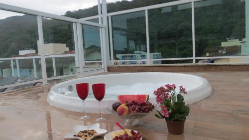 Imagen de la galería de Cobertura Santorini Nova com Spa e Solário na Praia Grande, en Ubatuba