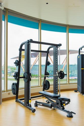 a gym with two treadmills and a large window at Regal Collection House in Dương Cảnh