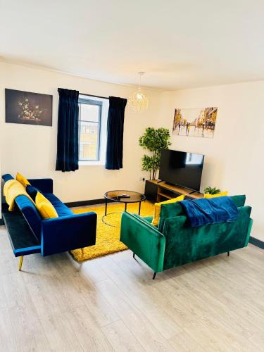a living room with two couches and a tv at Apartment with Balcony near Chatham Dockside in Brompton