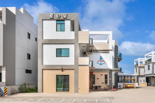 a facade of a building with white and gray at Summer Crazy in Huxi
