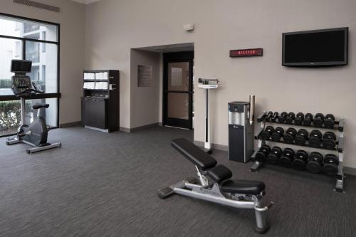 a fitness room with exercise equipment and a flat screen tv at Courtyard by Marriott Nashville Airport in Nashville