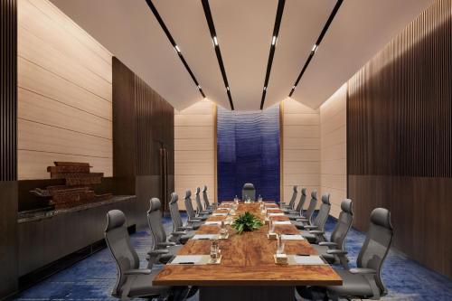 a conference room with a long table and chairs at JW Marriott Mumbai Juhu in Mumbai