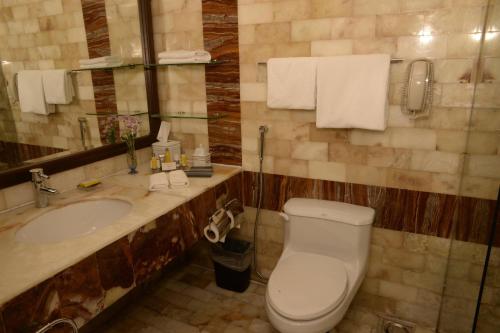 a bathroom with a toilet and a sink at Karachi Marriott Hotel in Karachi