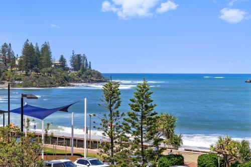 a view of a beach and the ocean at Absolute Beachfront Rolling Surf Resort in Caloundra