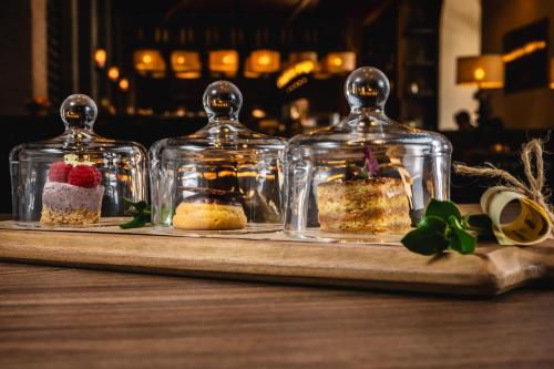 three desserts in glass jars on a table at JW Marriott El Convento Cusco in Cusco