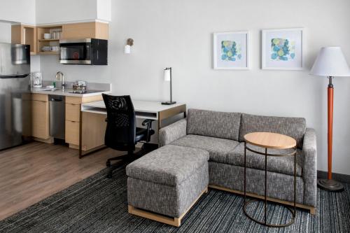 a living room with a couch and a table and a kitchen at TownePlace Suites Wilmington Newark / Christiana in Newark