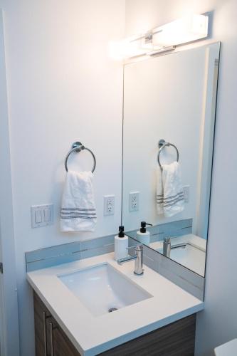 a bathroom with a sink and a mirror at Explore Seattle - Free Parking, Steps to Light Rail, Stadiums and VA in Seattle