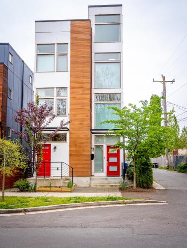 a building with red doors on a street at Explore Seattle - Free Parking, Steps to Light Rail, Stadiums and VA in Seattle