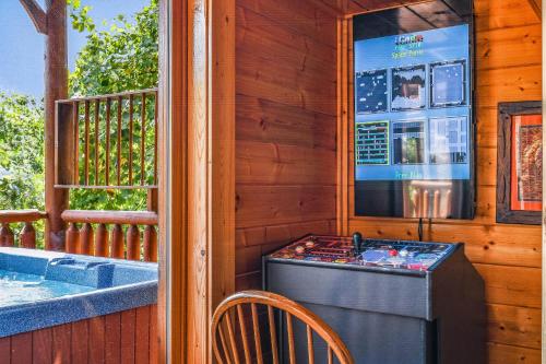 a porch with a hot tub and a table and chair at Extravagant View Cabin in Park Settlement