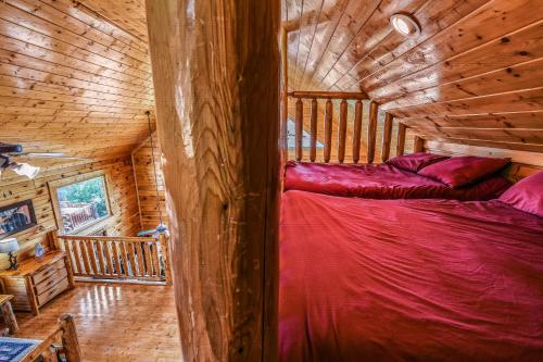 a bedroom in a log cabin with a bed in it at Extravagant View Cabin in Park Settlement