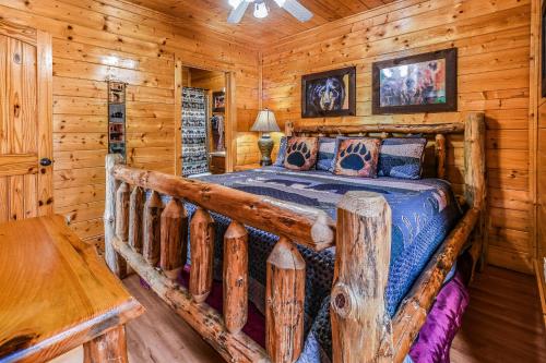 a bedroom with a bed in a log cabin at Extravagant View Cabin in Park Settlement