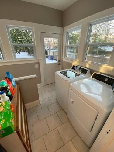 a kitchen with a washing machine and a washer at Historic District Home in Russellville