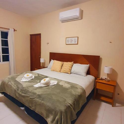 a bedroom with a bed with towels on it at Casa Azul Cielo in Dzilam de Bravo