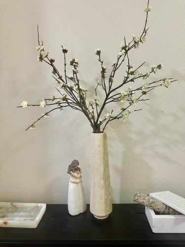 a vase with flowers in it on a table at Cozy Gem Near Old Town Pasadena in Pasadena
