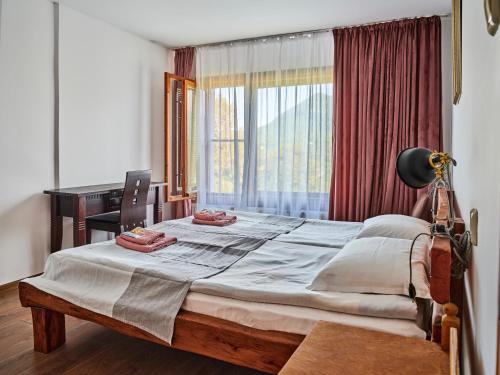 Ένα ή περισσότερα κρεβάτια σε δωμάτιο στο Hotel Tihiat Kat