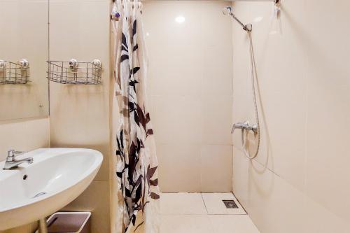 a bathroom with a sink and a shower at Fancy and Nice Studio at Atria Residence Gading Serpong Apartment By Travelio in Tangerang