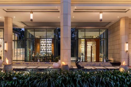 a lobby of a building with windows and plants at The Ritz-Carlton, Bangalore in Bengaluru
